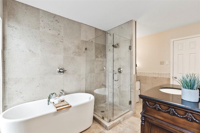 3309 Citation Dr, Dallas, TX 75229 - full bathroom with a soaking tub, a stall shower, tile walls, vanity, and tile patterned floors