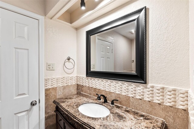 3309 Citation Dr, Dallas, TX 75229 - bathroom featuring vanity, a textured wall, and a wainscoted wall