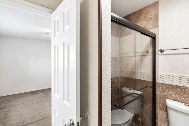 3309 Citation Dr, Dallas, TX 75229 - bathroom featuring toilet, a stall shower, and a textured wall
