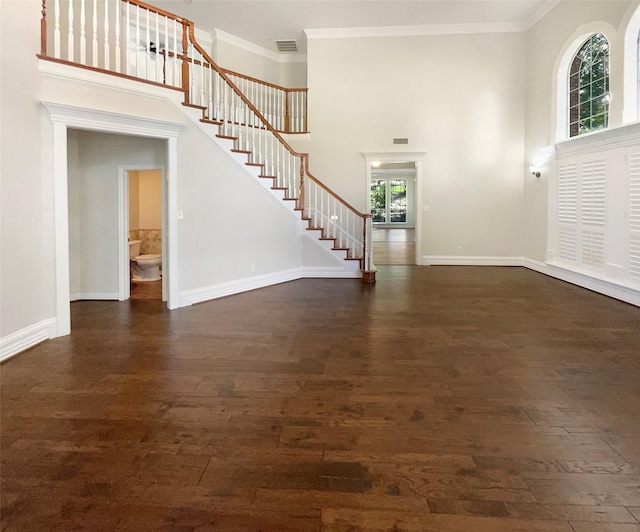 6029 Bellaire Dr, Benbrook, TX 76132 - entrance foyer with a high ceiling, stairway, wood finished floors, ornamental molding, and baseboards