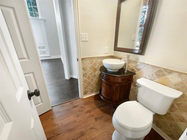 6029 Bellaire Dr, Benbrook, TX 76132 - bathroom with tile walls, wainscoting, wood finished floors, vanity, and toilet