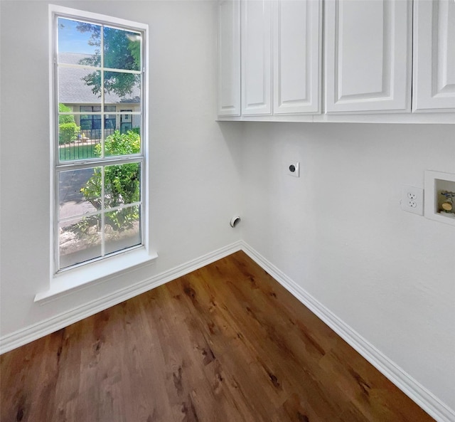 6029 Bellaire Dr, Benbrook, TX 76132 - laundry area featuring electric dryer hookup, cabinet space, baseboards, hookup for a washing machine, and dark wood finished floors