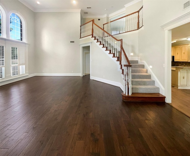 6029 Bellaire Dr, Benbrook, TX 76132 - unfurnished living room featuring dark wood-type flooring, a high ceiling, stairway, ornamental molding, and recessed lighting