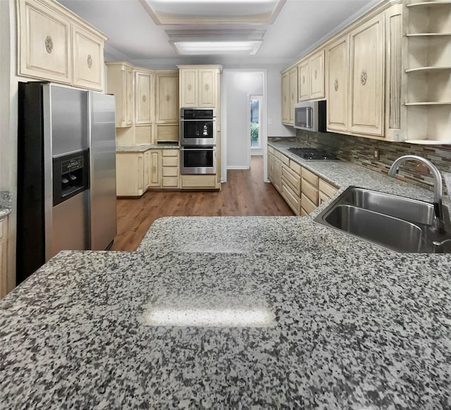 6029 Bellaire Dr, Benbrook, TX 76132 - kitchen featuring stainless steel appliances, light brown cabinetry, decorative backsplash, dark wood-style floors, and open shelves