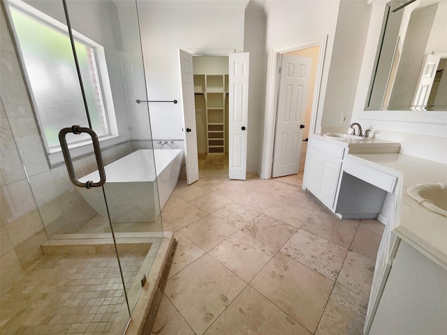 6029 Bellaire Dr, Benbrook, TX 76132 - bathroom featuring double vanity, a freestanding tub, a spacious closet, and a stall shower