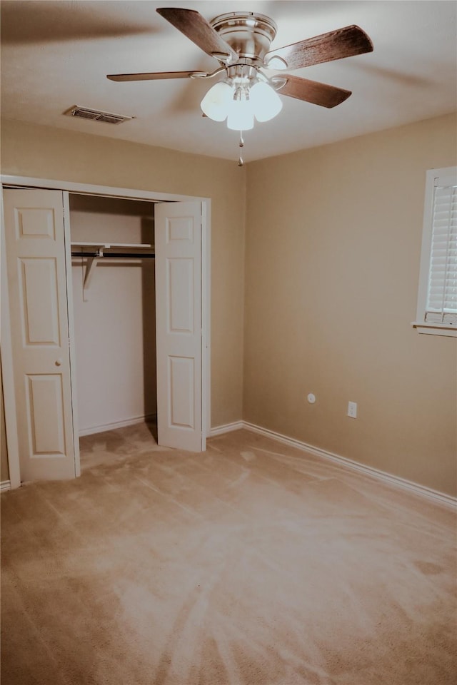 248 Ellis St, Rusk, TX 75785 - unfurnished bedroom featuring a closet, light carpet, baseboards, and a ceiling fan