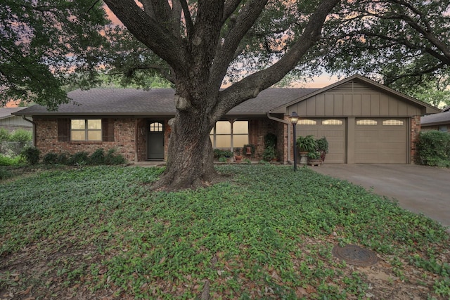 1113 Stanley St, Denton, TX 76201 - view of front of home with a garage, concrete driveway, brick siding, and roof with shingles