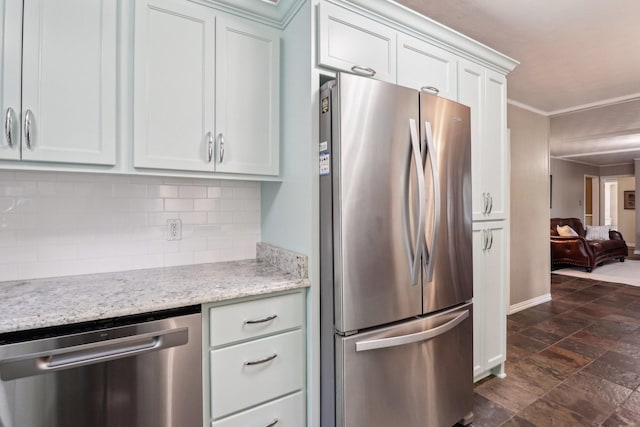 1113 Stanley St, Denton, TX 76201 - kitchen featuring appliances with stainless steel finishes, decorative backsplash, white cabinets, crown molding, and light stone counters
