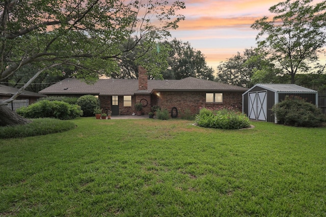 1113 Stanley St, Denton, TX 76201 - rear view of house featuring a chimney, a yard, brick siding, and roof with shingles
