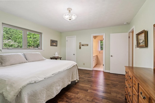 1113 Stanley St, Denton, TX 76201 - bedroom featuring dark wood-type flooring, baseboards, and connected bathroom
