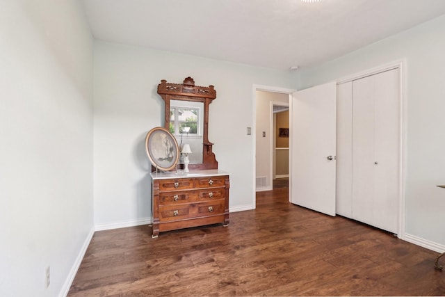 1113 Stanley St, Denton, TX 76201 - bedroom with dark wood finished floors, baseboards, and a closet