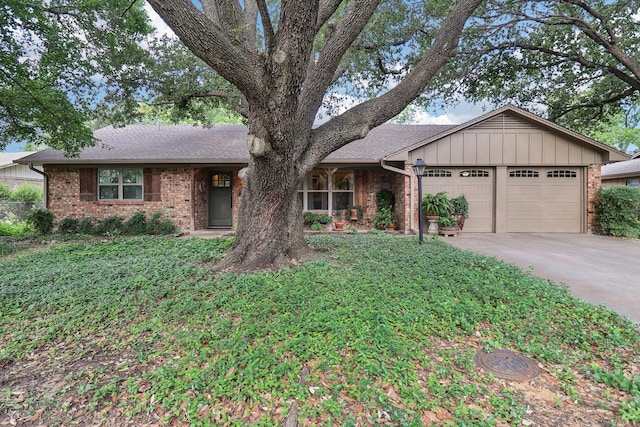 1113 Stanley St, Denton, TX 76201 - ranch-style home featuring an attached garage, concrete driveway, brick siding, and a shingled roof