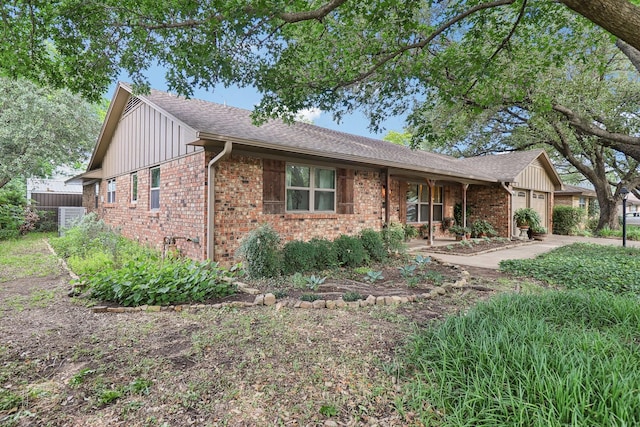 1113 Stanley St, Denton, TX 76201 - single story home featuring brick siding, a garage, board and batten siding, and roof with shingles