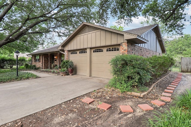 1113 Stanley St, Denton, TX 76201 - ranch-style house featuring board and batten siding, a garage, concrete driveway, roof with shingles, and brick siding