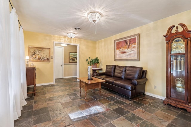 1113 Stanley St, Denton, TX 76201 - living room featuring stone tile floors and baseboards