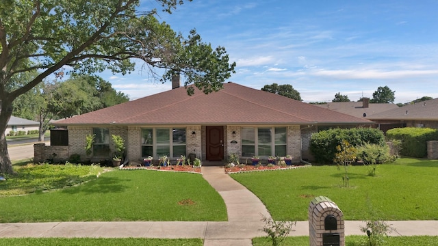 2612 Windsor Pl, Plano, TX 75075 - view of front of home with brick siding, a front lawn, and a chimney