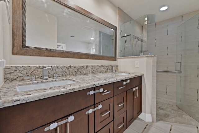 2612 Windsor Pl, Plano, TX 75075 - bathroom featuring a shower stall, double vanity, tile patterned floors, and recessed lighting