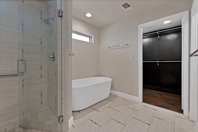 2612 Windsor Pl, Plano, TX 75075 - full bath with a stall shower, a soaking tub, baseboards, and recessed lighting