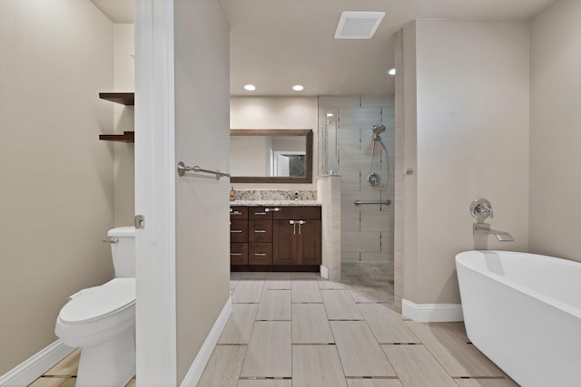2612 Windsor Pl, Plano, TX 75075 - bathroom with vanity, a stall shower, a freestanding bath, toilet, and recessed lighting