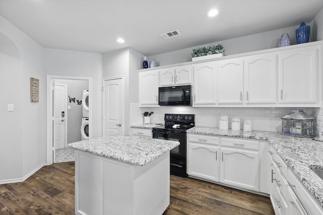 2408 Charisma Dr, Fort Worth, TX 76131 - kitchen featuring black appliances, estacked washer and dryer, white cabinetry, tasteful backsplash, and dark wood-style flooring