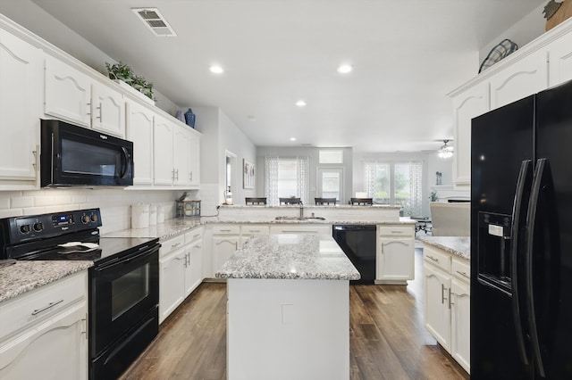 2408 Charisma Dr, Fort Worth, TX 76131 - kitchen featuring black appliances, a peninsula, ceiling fan, white cabinetry, and decorative backsplash