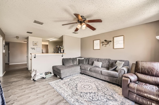 1806 Willowbrook Dr, Terrell, TX 75160 - living room with a ceiling fan, wood finished floors, a textured ceiling, and baseboards