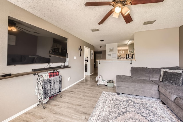 1806 Willowbrook Dr, Terrell, TX 75160 - living room featuring a ceiling fan, wood finished floors, a textured ceiling, and baseboards