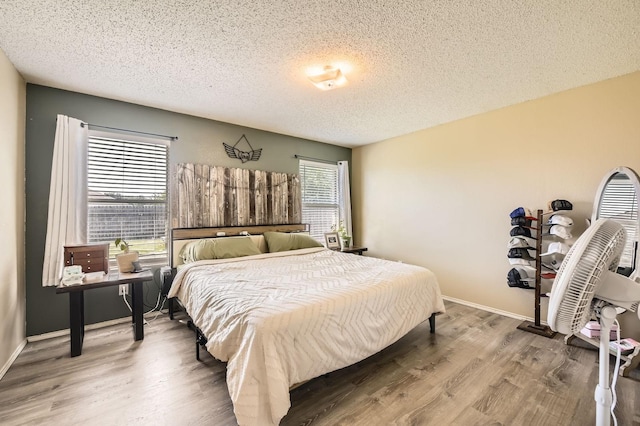 1806 Willowbrook Dr, Terrell, TX 75160 - bedroom with a textured ceiling, wood finished floors, and baseboards