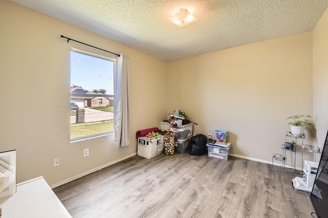 1806 Willowbrook Dr, Terrell, TX 75160 - miscellaneous room featuring wood finished floors, a textured ceiling, and baseboards