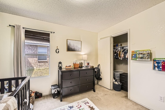 1806 Willowbrook Dr, Terrell, TX 75160 - bedroom featuring light colored carpet, a textured ceiling, and a closet