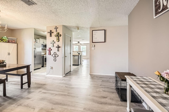 1806 Willowbrook Dr, Terrell, TX 75160 - hallway featuring a textured ceiling, light wood-style flooring, and baseboards