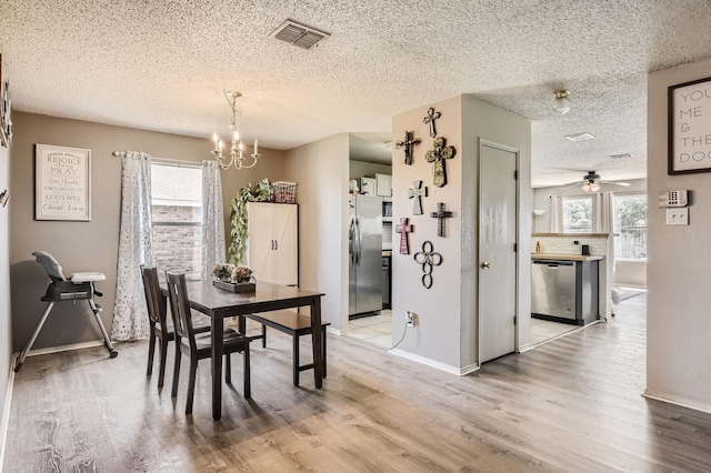 1806 Willowbrook Dr, Terrell, TX 75160 - dining area with a chandelier, healthy amount of natural light, light wood-type flooring, and a textured ceiling