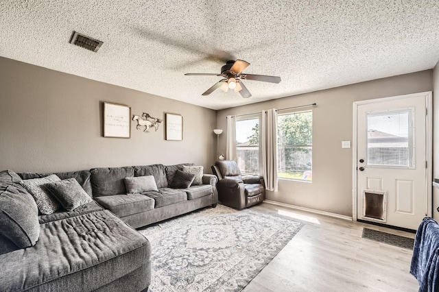 1806 Willowbrook Dr, Terrell, TX 75160 - living room featuring a ceiling fan, wood finished floors, a textured ceiling, and baseboards