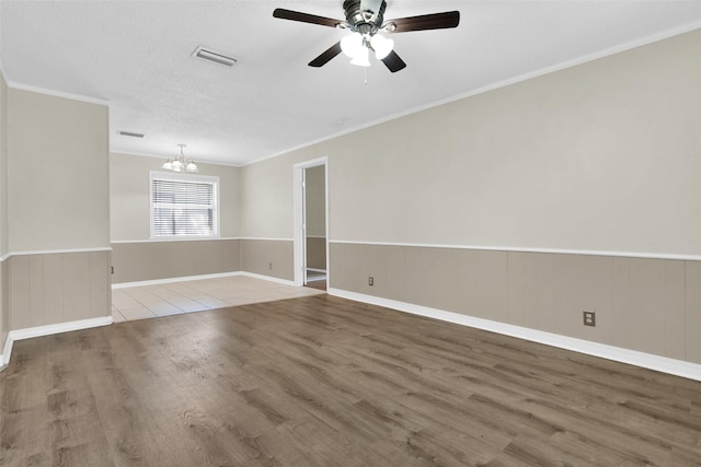106 King Ave, Howe, TX 75459 - spare room with a chandelier, wood finished floors, crown molding, a ceiling fan, and wainscoting