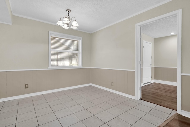 106 King Ave, Howe, TX 75459 - unfurnished room with a textured ceiling, a chandelier, wainscoting, crown molding, and light tile patterned flooring