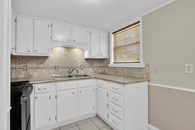 106 King Ave, Howe, TX 75459 - kitchen featuring black range with electric stovetop, a sink, a wainscoted wall, white cabinets, and tasteful backsplash