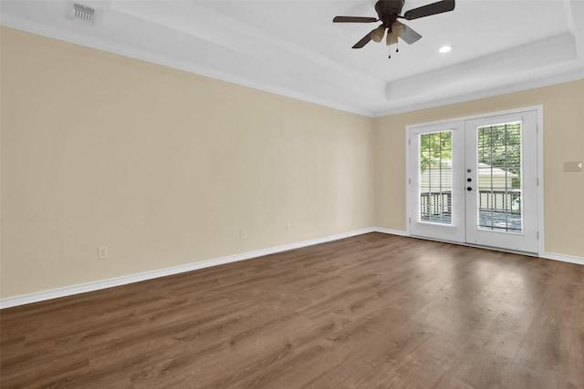 312 W Young St, Howe, TX 75459 - spare room featuring a tray ceiling, ceiling fan, dark wood-style floors, french doors, and baseboards