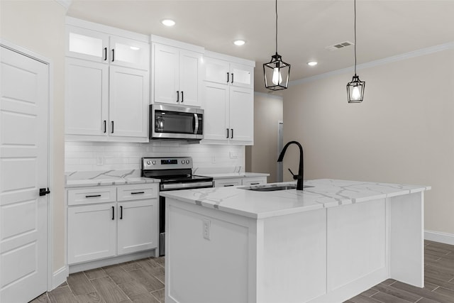 2325 Neches St, Granbury, TX 76048 - kitchen with stainless steel appliances, a sink, white cabinets, a kitchen island with sink, and decorative backsplash