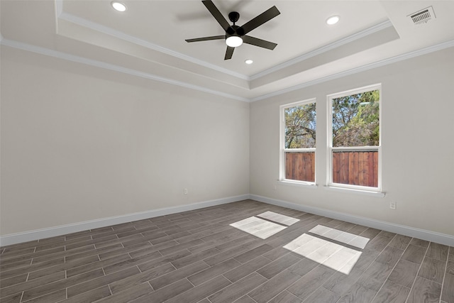 2325 Neches St, Granbury, TX 76048 - spare room featuring a tray ceiling, ceiling fan, ornamental molding, baseboards, and dark wood finished floors
