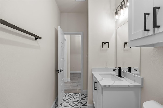 2325 Neches St, Granbury, TX 76048 - bathroom featuring vanity, toilet, and baseboards