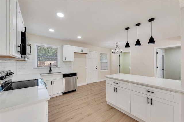1628 Florence St, Arlington, TX 76010 - kitchen featuring appliances with stainless steel finishes, a sink, backsplash, white cabinets, and light wood-type flooring