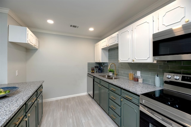620 Admiralty Way, Fort Worth, TX 76108 - kitchen featuring appliances with stainless steel finishes, a sink, white cabinets, tasteful backsplash, and crown molding