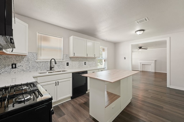 2806 W 8th St, Dallas, TX 75211 - kitchen with black appliances, a sink, decorative backsplash, a ceiling fan, and dark wood-style floors