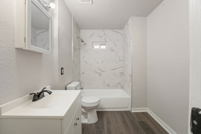 2806 W 8th St, Dallas, TX 75211 - full bathroom featuring wood finished floors, a textured wall, toilet, vanity, and tub / shower combination