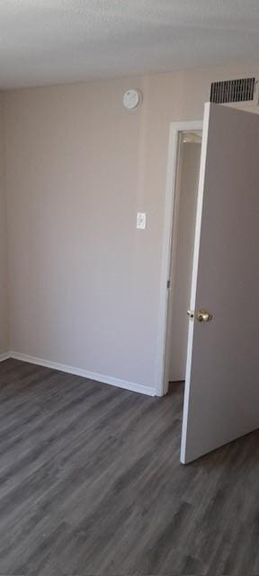 8110 Skillman St Unit 2054, Dallas, TX 75231 - spare room featuring dark wood finished floors, a smoke detector, and baseboards