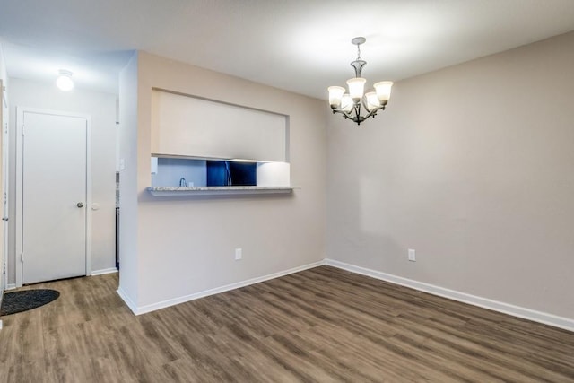 8110 Skillman St Unit 2054, Dallas, TX 75231 - spare room featuring wood finished floors and a chandelier