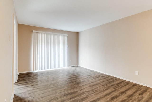 8110 Skillman St Unit 2054, Dallas, TX 75231 - empty room featuring dark wood-style floors and baseboards