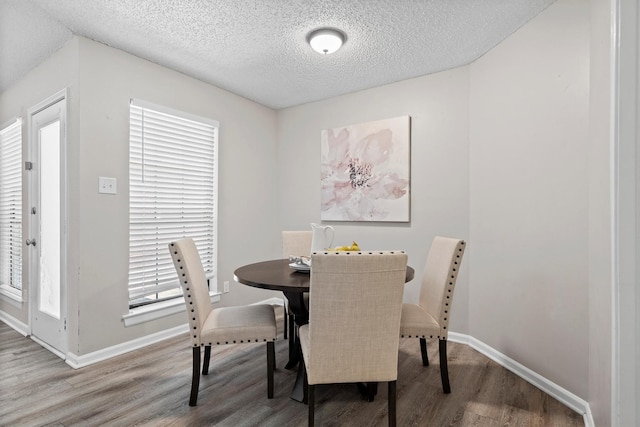 220 Timber Ridge Ln, Coppell, TX 75019 - dining area featuring wood finished floors, baseboards, and a textured ceiling