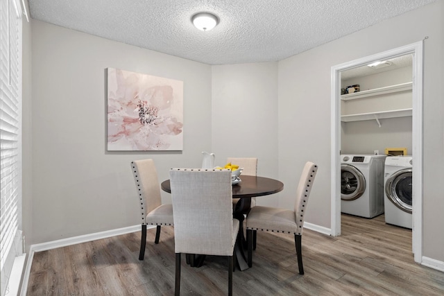 220 Timber Ridge Ln, Coppell, TX 75019 - dining room with washer and dryer, wood finished floors, a textured ceiling, and baseboards