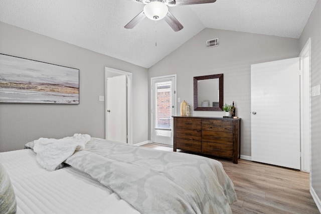 220 Timber Ridge Ln, Coppell, TX 75019 - bedroom featuring light wood finished floors, lofted ceiling, a textured ceiling, baseboards, and a ceiling fan